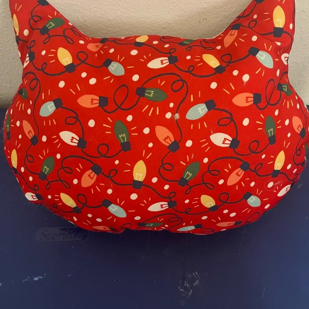 Wonder shop have a very furry Christmas cat pillow